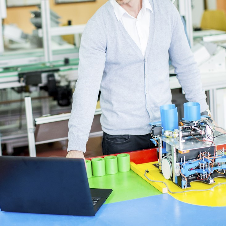 Professional engineer working with automated testing equipment in modern laboratory